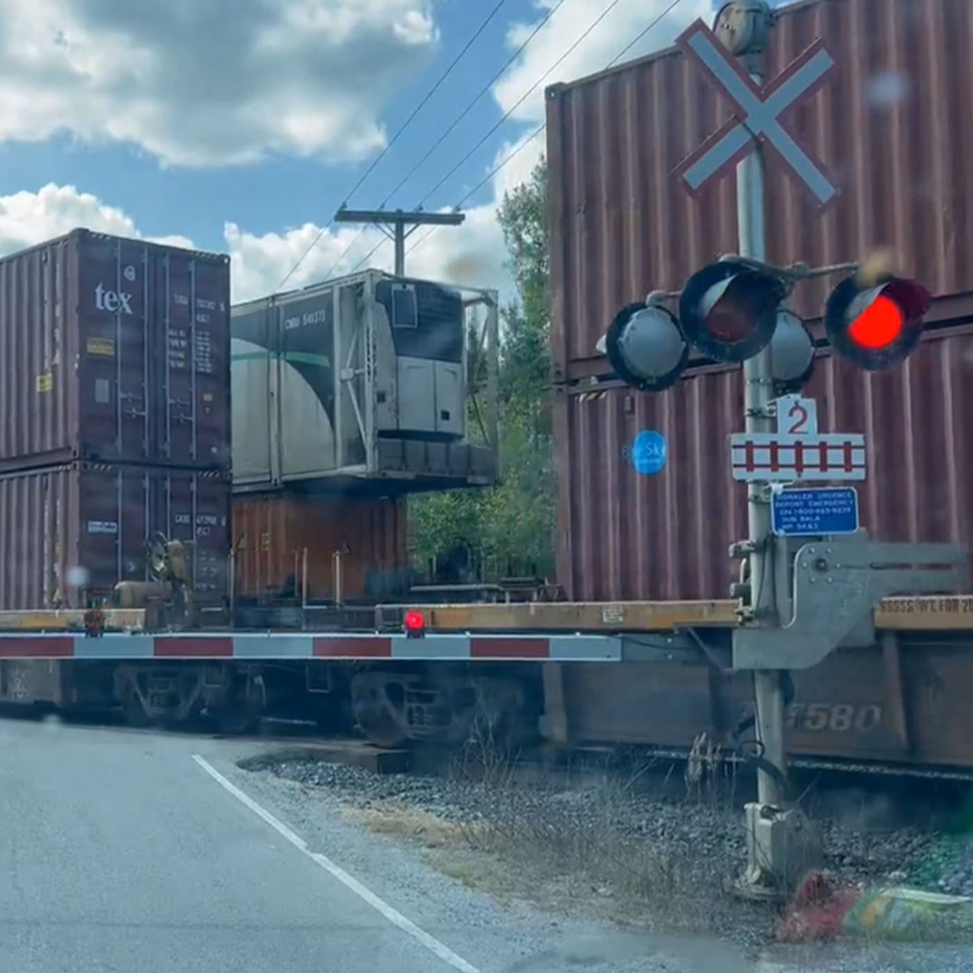 Loco at active crossing with gate and lights — Episode 2 still